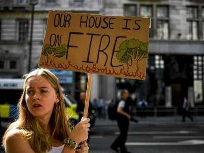 Extinction Rebellion demonstrators gather outside the Brazilian Embassy in London to protest and raise awareness about the massive fires in the Amazon rainforest, Aug. 23.
