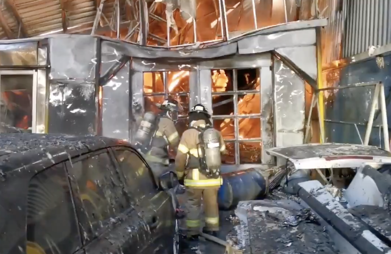 Firefighters attend to a fire in Parque Lefevre