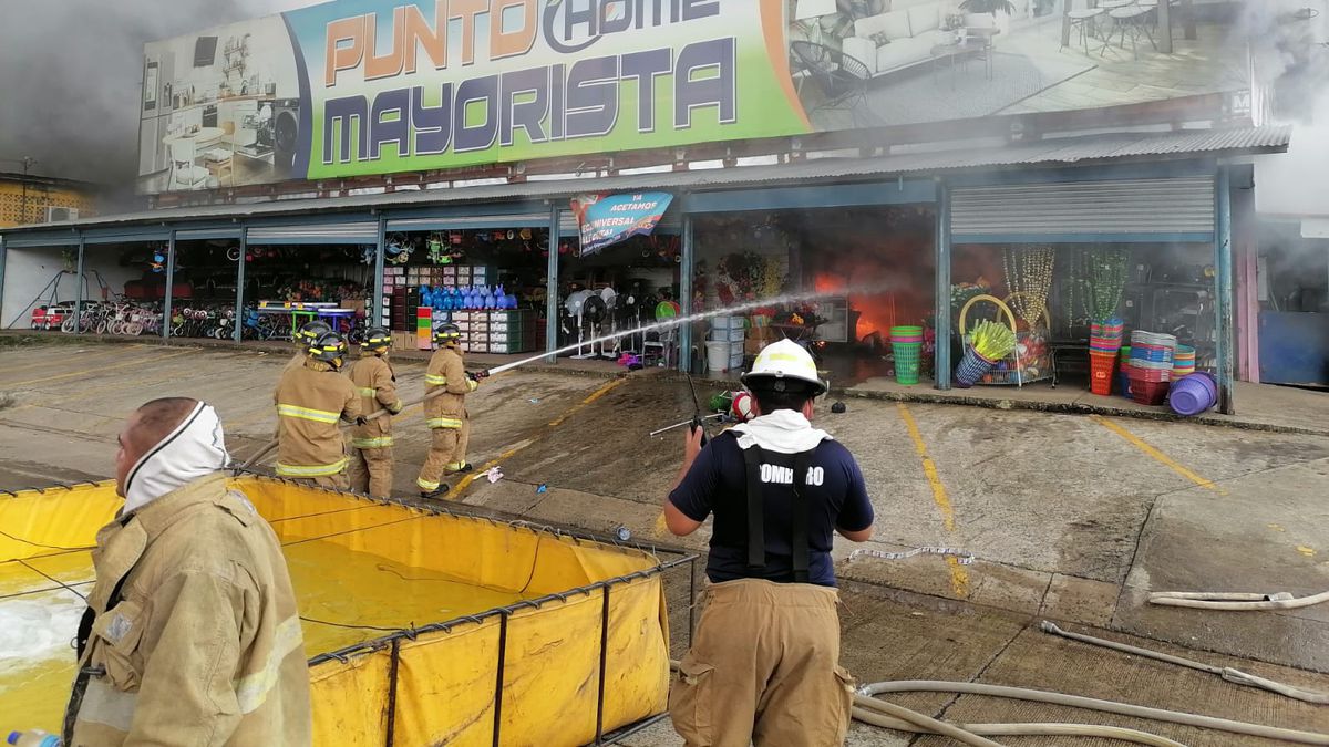 Firefighters attend a fire in a warehouse in Santiago
