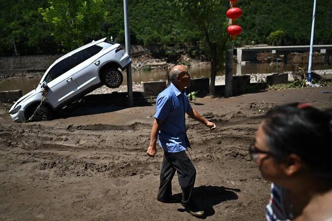 Beijing expands storm alert as fatal floods keep city on edge