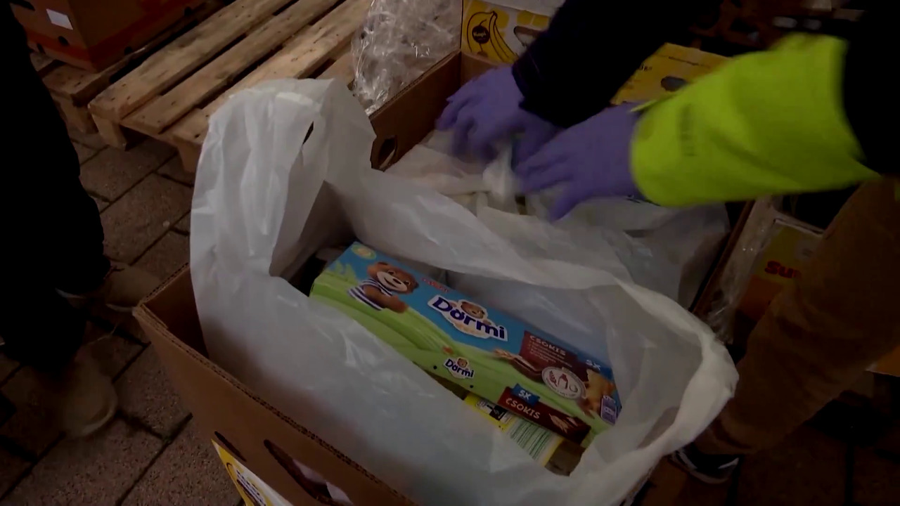 Residents of Budapest line up for food distributed by a charity on a cold day in December