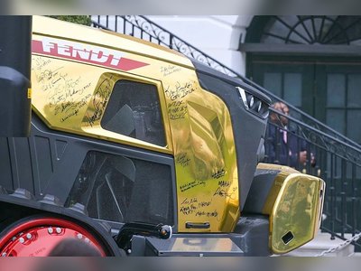 Trump Draws Attention at Event After Admiring Striking Gold Tractor Display